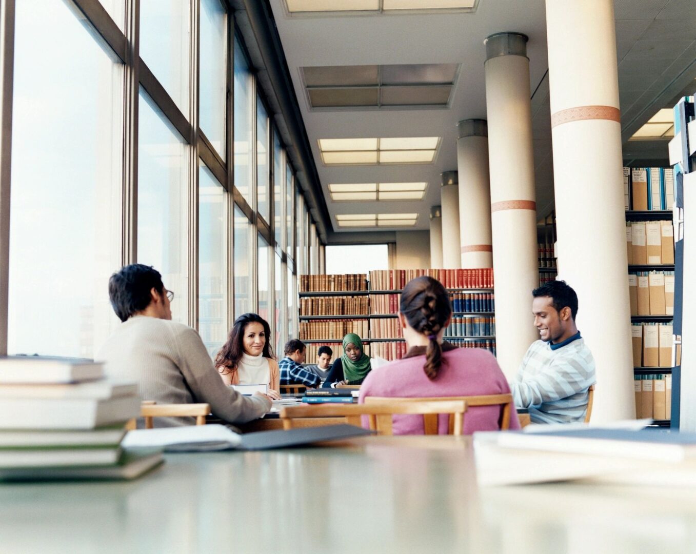 A diverse group of students meeting in a library.